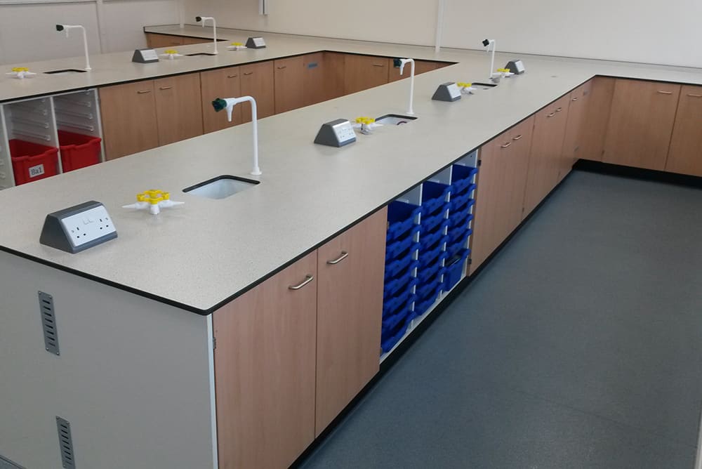 Science laboratory furniture island unit with blue trays