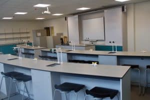 Bury College science laboratory teaching wall and desks.