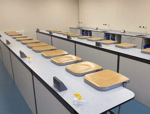 Balcarras School science lab furniture straight island layout with beech stools