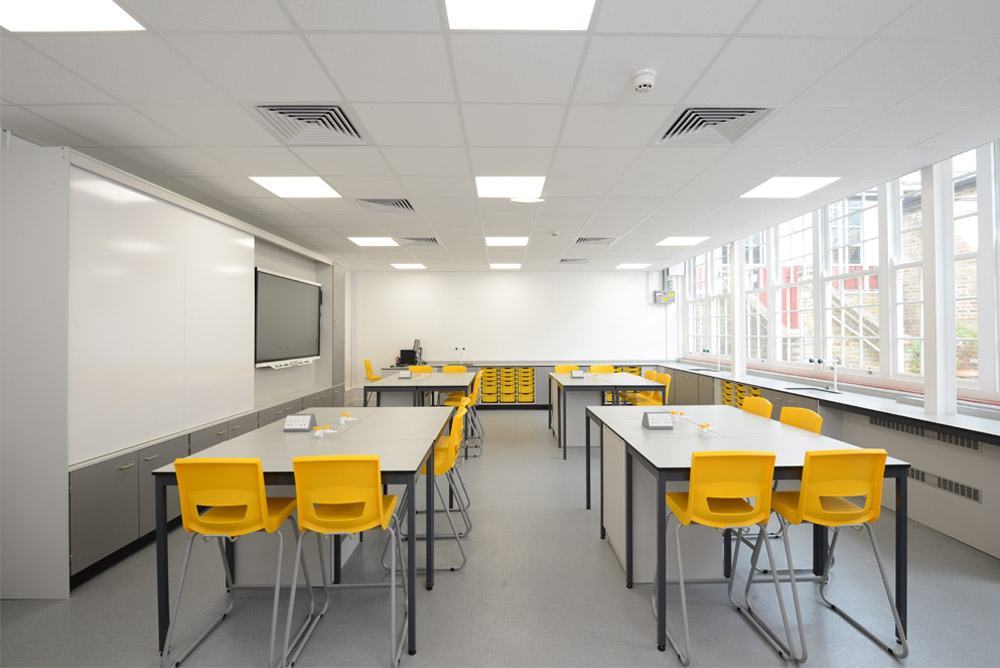 Royal Ballet School science laboratory with loose tables and teaching wall