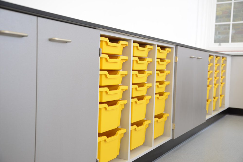 Royal Ballet School science laboratory with perimeter benching and yellow tray storage