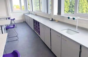 School science lab perimeter benching with purple trays.