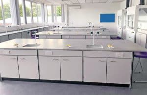 Integrated storage & ceramic sinks in school science laboratory.