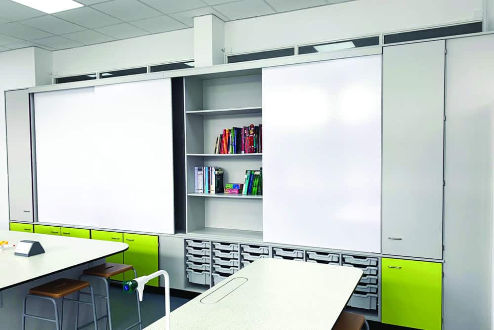 Teaching wall with sliding doors and tray storage